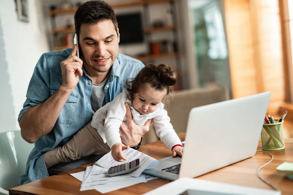 Houston Custodial Parent Holding Baby at Desk