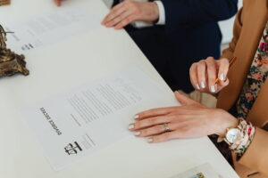 woman's hand on divorce documents